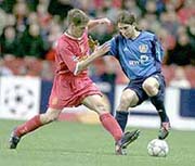 Liverpool's Michael Owen, left, challenges Diego Placente of Bayer Leverkusen for the ball, during their UEFA Champion's League quarterfinal, first leg match at Anfield, Liverpool on Wednesday.