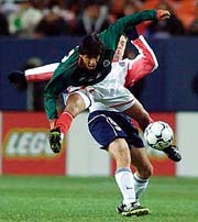 Mexico National team member Alberto Rodriguez (front) battles with USA National team member Richard Mulrooney for control of the ball in the first half in Denver on Wednesday.