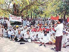 Members of several farmers’ organisations protest against “non-remunerative” prices of rabi crops, in Ludhiana on Friday.
