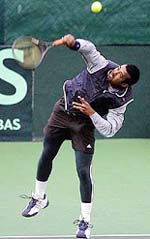 Indias Leander Paes playing with Mahesh Bhupathi takes a shot