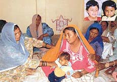 A grieving Ms Kiran Singh, whose two children died after eating poisonous burfi on Monday night near Lalru. (Inset) Nisha and Akash.