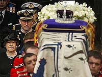 The Queen (L) and Prince Charles walk behind the Queen Mother's coffin