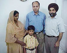 Neelam Rani and her son, Arun Kumar, with two doctors at Jalandhars BBC Heart Care Centre.