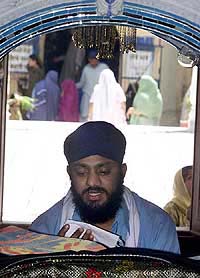A pilgrim recites from Guru Granth Sahib