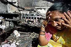 A woman sits in her house in Kalyan