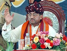 Pakistan President Pervez Musharraf, wearing a traditional Sindhi turban, waves to supporters