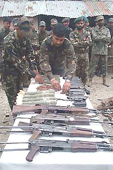 Army personnel display arms and ammunition