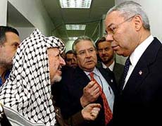 Palestinian leader Yasser Arafat talks to US Secretary of State Colin Powell before their meeting at Arafats besieged office in Ramallah on Sunday.