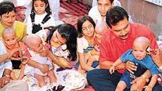 Devotees with their children after performing mundan ceremony at the Mata Mansa Devi temple complex in Panchkula on Monday.