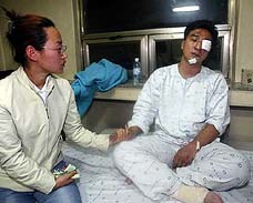 South Korean passenger Sul il-su sits on a hospital bed