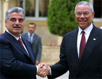 U.S. Secretary of State Colin Powell (right) is greeted by Lebanese Prime Minister