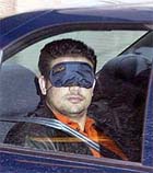 A blindfolded suspected al Qaeda member 