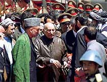 Head of the Interim Afghan government, Hamid Karzai holds Afghanistan 's ex-king 