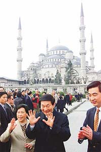 Chinese Premier Zhu Rongji (C) and his wife Lao An (L) gesture to media members