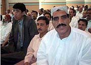 Pakistan's tallest man Naseer Soomro (2nd L) and second tallest Mazari (R front) attend a meeting 