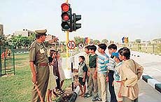A policeman explains traffic rules to kids at the Children’s Traffic Park inaugurated by the Haryana Chief Minister in Sector 12, Panchkula, on Tuesday.