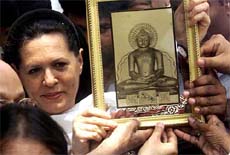 Congress President Sonia Gandhi with a portrait of god Mahavir