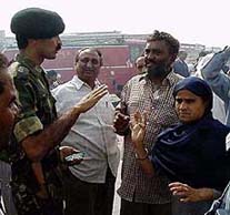 An Army officer talks to a group of people