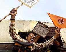 A VHP activist shouts slogans as he courts arrest during a demonstration