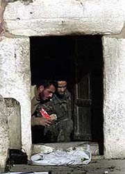 Two Palestinians take food left by international peace activists