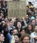 French students display a banner that reads "Facists, Nazis" during a demonstration in Paris