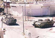 Israeli tanks destroy a Palestinian police position in Hebron