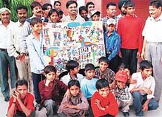Slum children present a painting to the DPI (Schools), Mr D.S Mangat