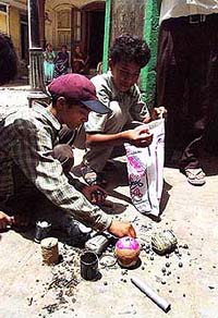 Children collect pellets for a manufacture