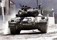 An Israeli tank rolls through Hebron