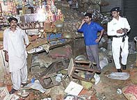Officials visit the site of a bomb blast