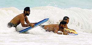 Members of the Indian cricket team surf at the Accra beach