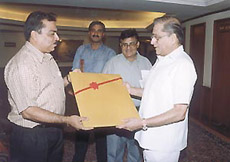 The president of the Board of Control for Cricket in India, Jagmohan Dalmia (right), being presented with his portrait by DDCA joint secretary Sunil Khanna in the Capital.