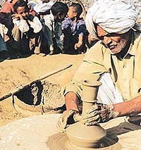 Udey of Pakasma village making a hukkah on the wheel