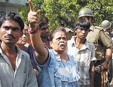 A woman shouts at police officers