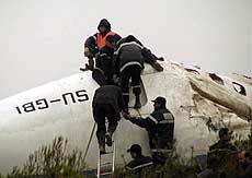 Rescue workers climb on to the wreckage of an EgyptAir