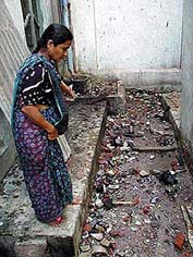 A resident of the Kalupur area shows stone pieces and home-made bombs, 