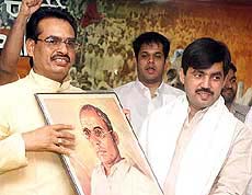 BJP Yuva Morha president Shiv Raj Singh Chauhan presents a portrait of Veer Savarkar