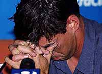 New Zealand cricket captain Stephen Fleming holds back tears during a news conference
