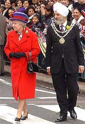 Britain's Queen Elizabeth II is accompanied by Councellor Sukhdev Singh Marway