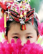 A South Korean girl wears a traditional outfit while attending a ceremony celebrating the approach of Buddha's birthday at Seoul's Chogye temple