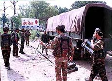 Army jawans taking away the arms and ammunitions recovered from the three militants