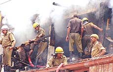 Firemen trying to douse the flames at Lajpat Rai Market
