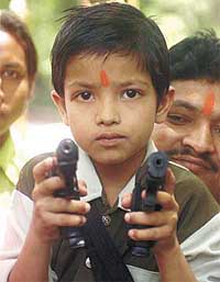 A child holding toy pistols