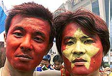 Chinese soccer supporters display their painted faces in support of the Chinese national team