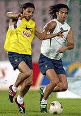 Portugal's soccer player Nuno Gomes (L) struggles with team mate 