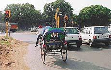 Traffic stops on a red signal at a slip lane traffic light point in Chandigarh.
