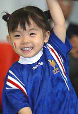 Two-year-old Japanese girl Cie wears a France national soccer team shirt