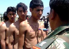 An Army officer marks Kashmiri youths