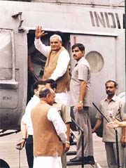 Prime Minister Atal Behari Vajpayee waves to media before his departure for Delhi after spending holidays at Manali