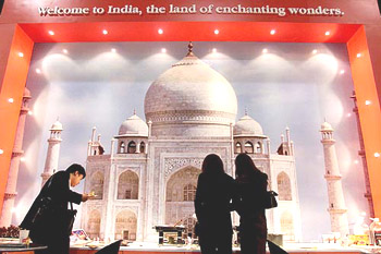 Visitors tour India's booth featuring a photograph of  the Taj Mahal